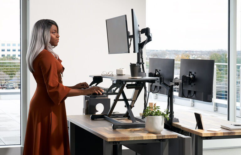 professional standing and working in front of an electric converter on top of a desk
