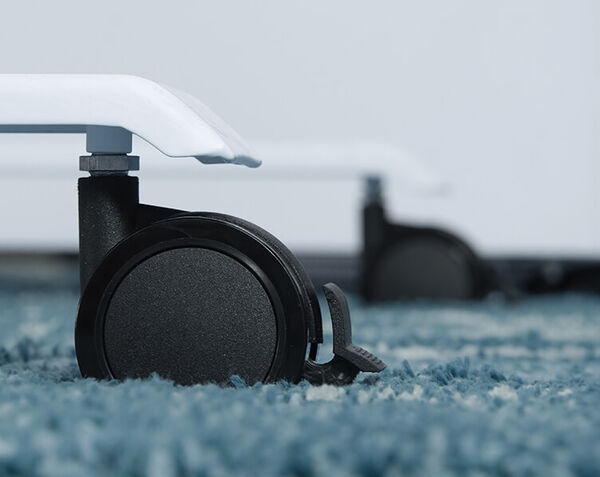 close up of caster on a carpeted surface