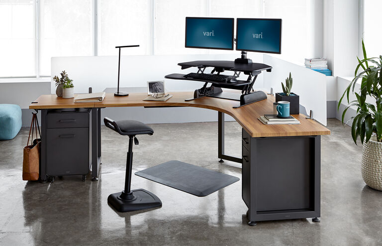 Individual working on VariDesk Cube Corner in office setting