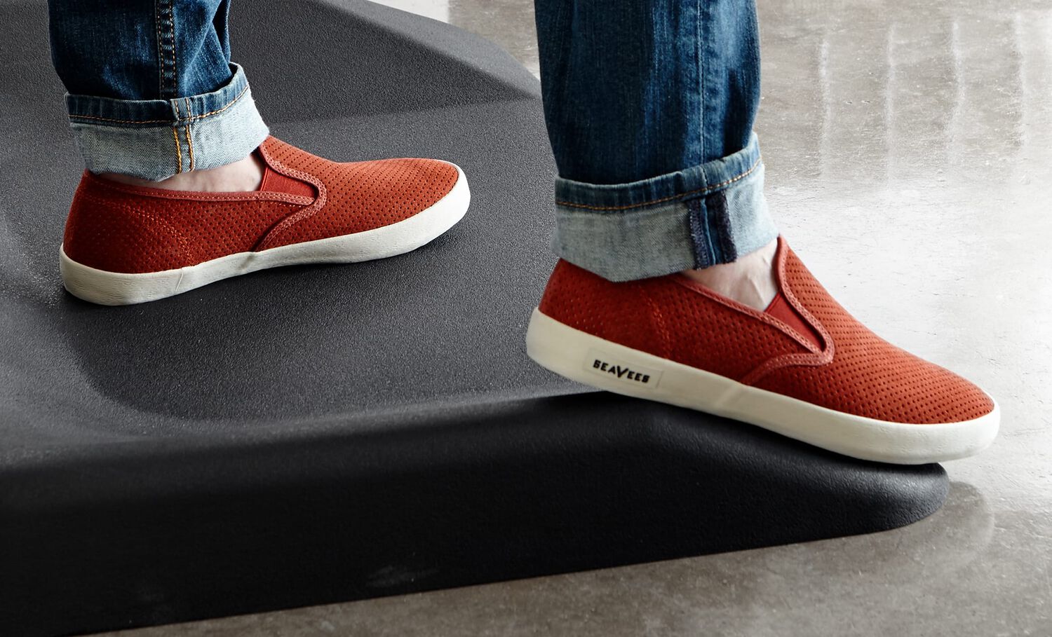 Individual standing on Vari active mat