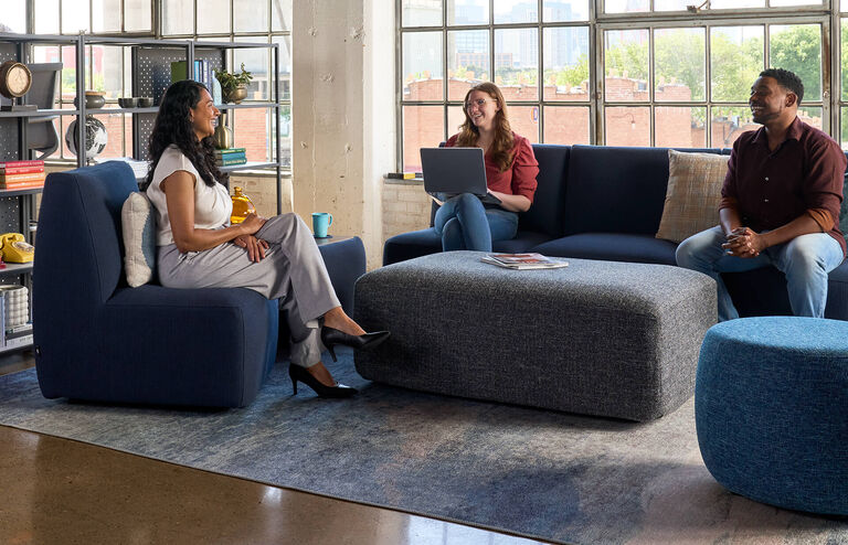 three individuals sitting on the haven side chairs and upholstered bench and talking