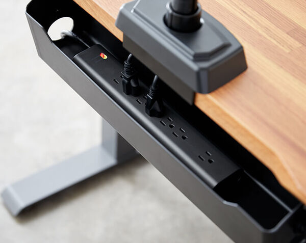 vari power strip inside of cable management tray on electric standing desk 