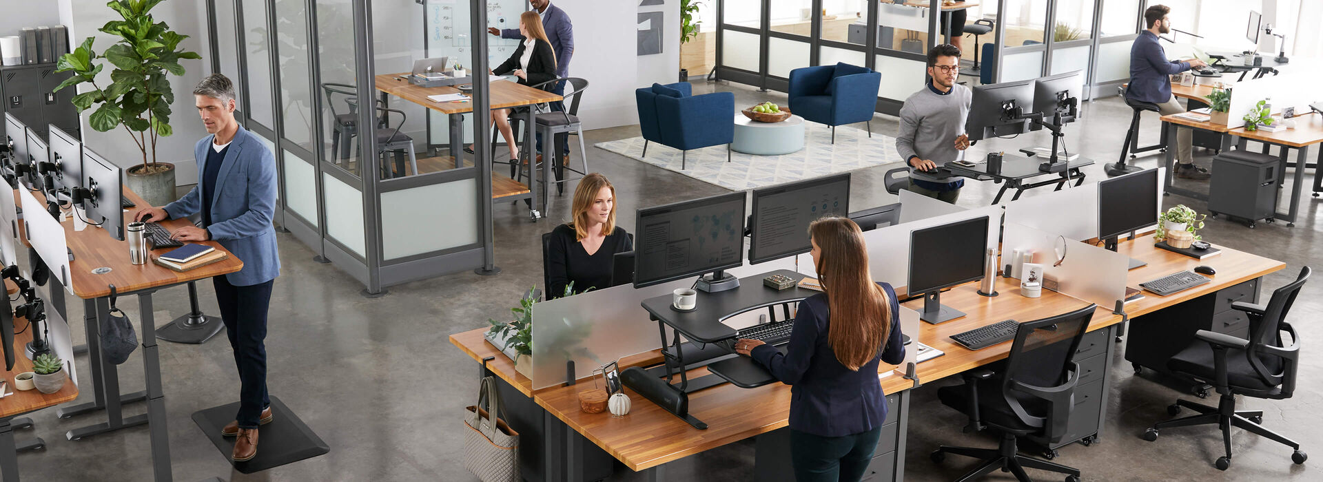 overhead view of professionals working at a variety of standing desk setups in office space