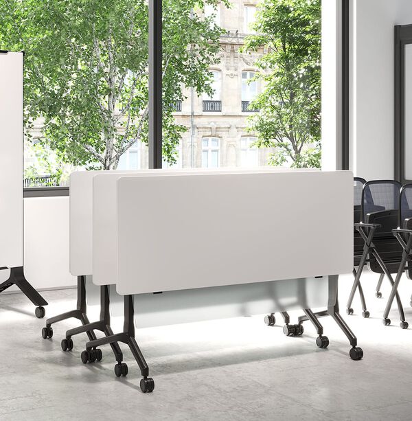 white tables folded up and nestled together 