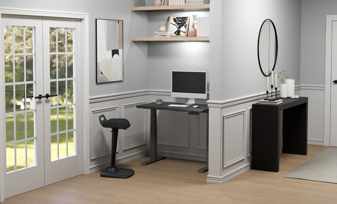 L-Shape electric standing desk setup in the corner of an open workspace