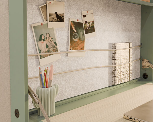 hide away desk zoomed in displaying decorated space and images