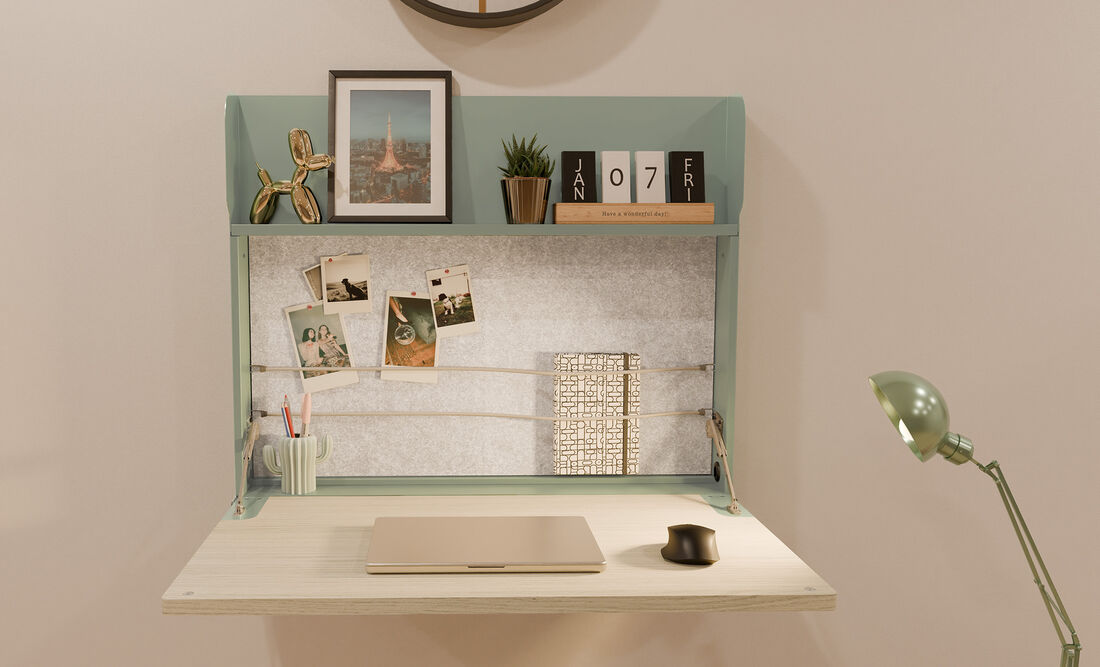 close up view of the hide-away desk in seafoam with laptop and accessories
