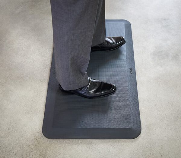 Professional standing on Vari Standing Mat