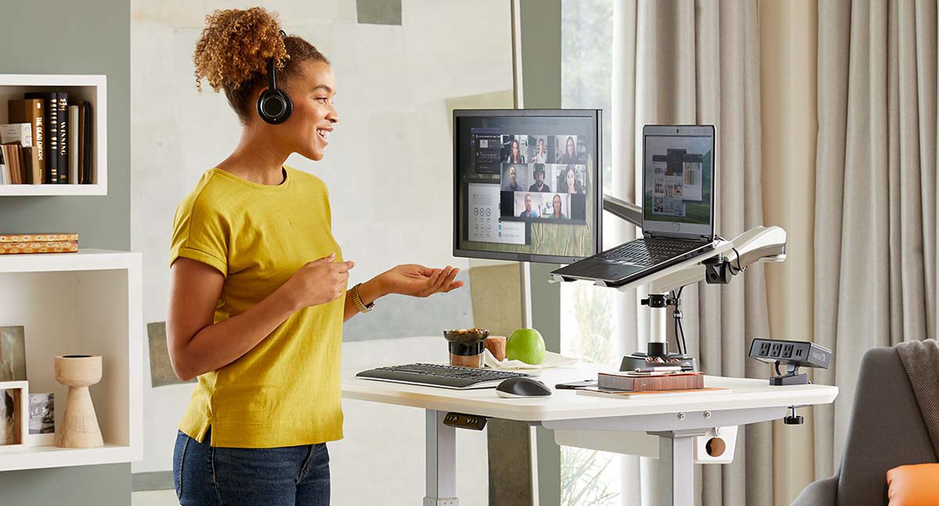 professional standing during virtual meeting with the electric standing desk 