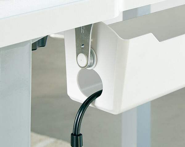 white cable management tray with a cable run through the cable opening