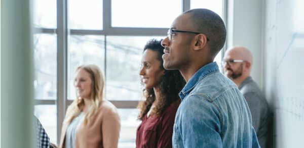 group of professionals watching presentation in office setting
