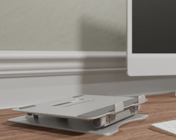 varidesk laptop stand folded flat on top of a desk
