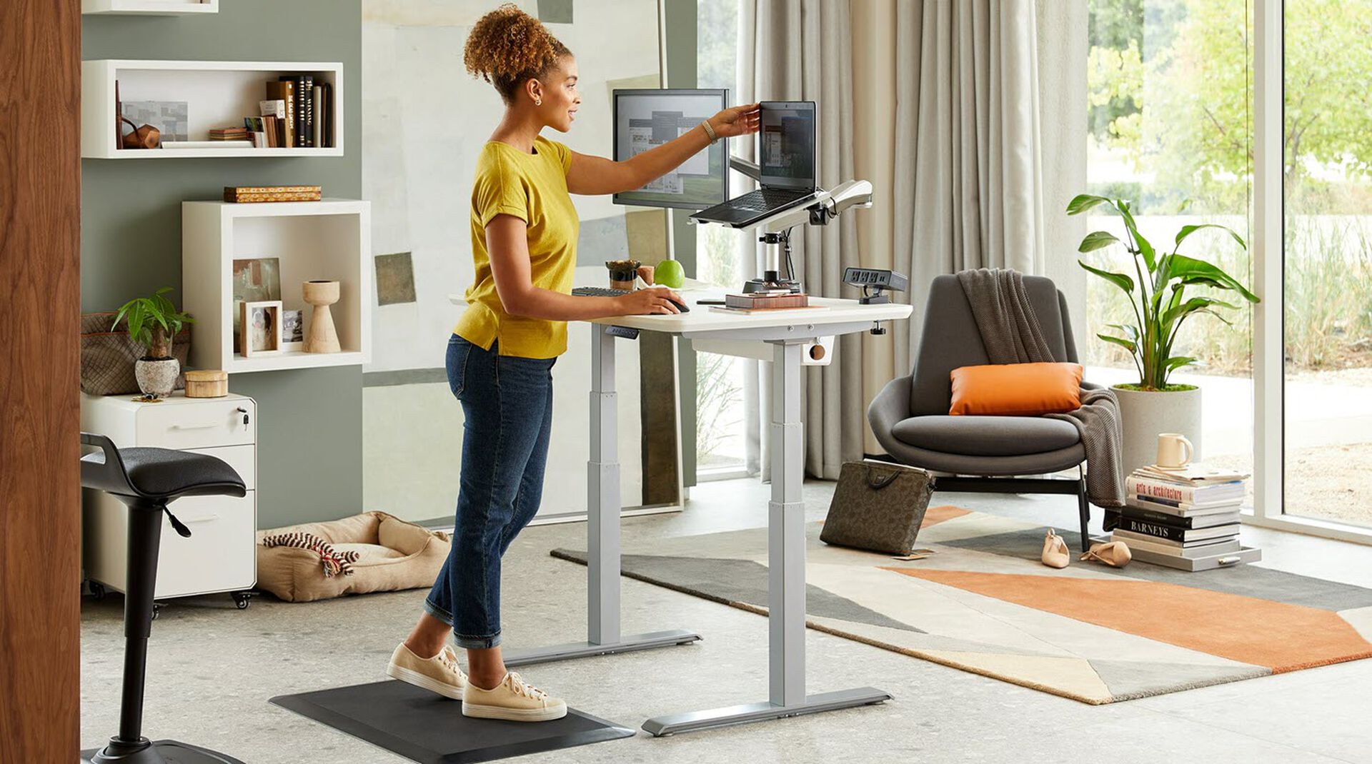 professional working at electric standing desk in home office 