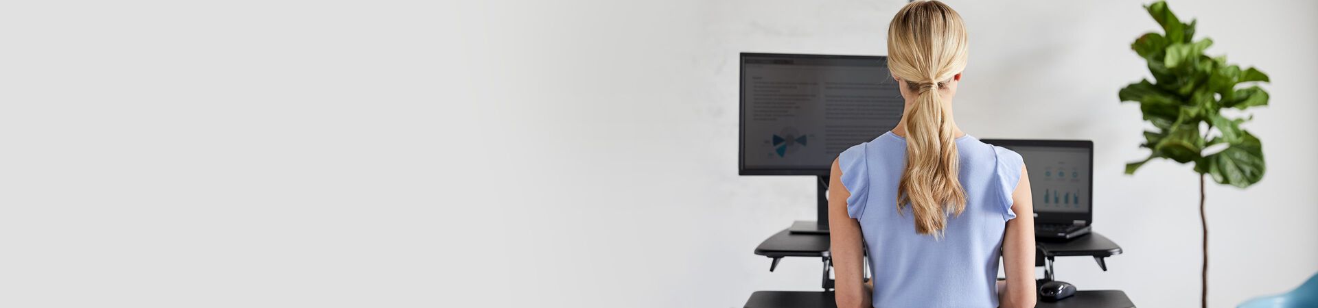 Professional using a standing desk converter