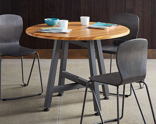 standard height table in office breakroom surrounded by three chairs