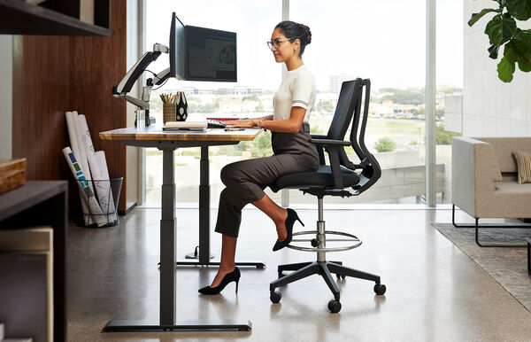 Professional seated in drafting chair 