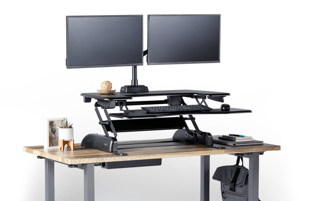 personal workstation VariDesk sit-stand converter placed on top of a fixed height desk