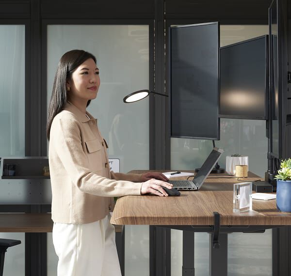 open laptop on a raised standing desk