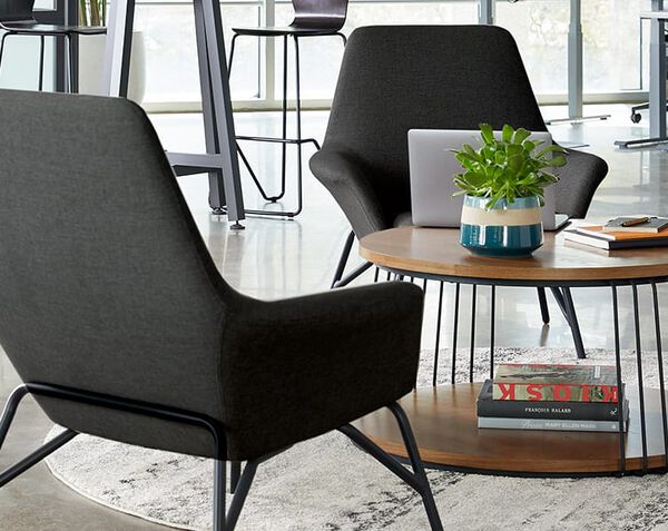 2 arm chairs and a table create a lounge area 