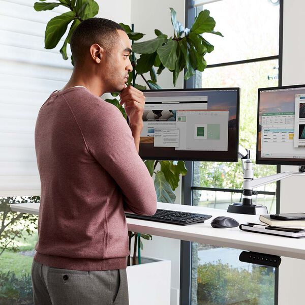 professional working while standing with electric standing desk 