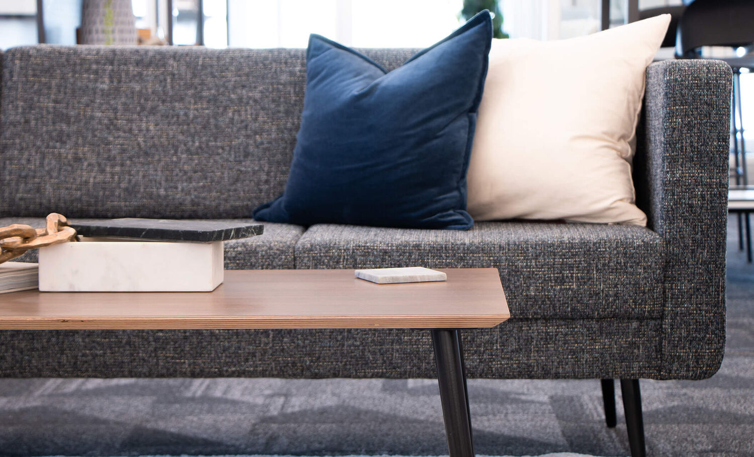 close up view of the aspire three seat sofa and the aspire coffee table 