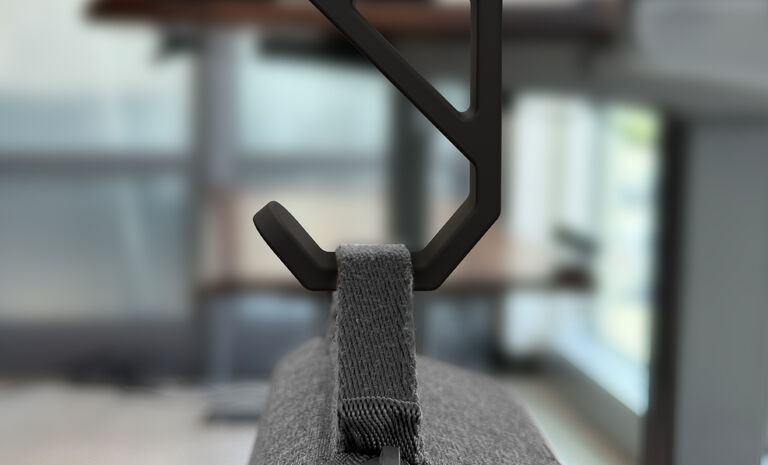 undermount bag hook attched to a desk or table shown holding a bag strap