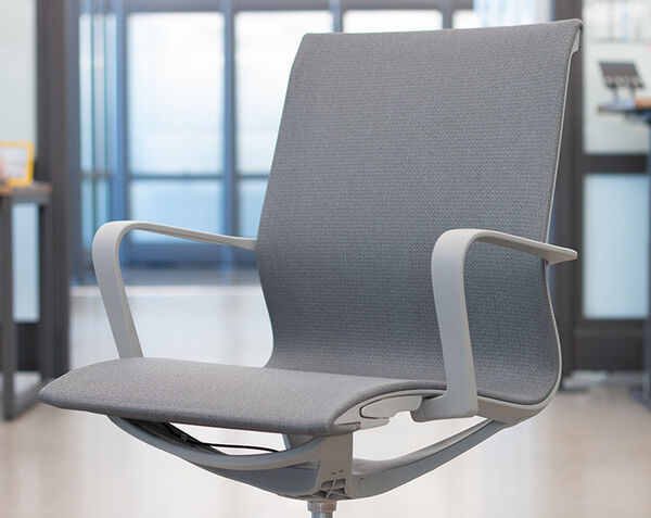 Close-up of Ascent chair lever beneath the seat for reclining or tilt adjustment.