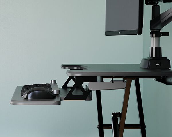 Front view of The Essential Vertical Lift 30, with a monitor and keyboard on top. 