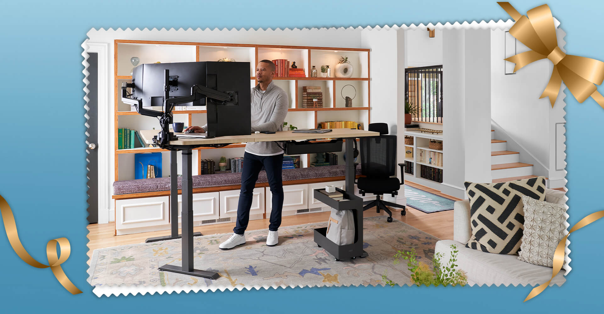 man standing at an l shape electric standing desk in a home office setting