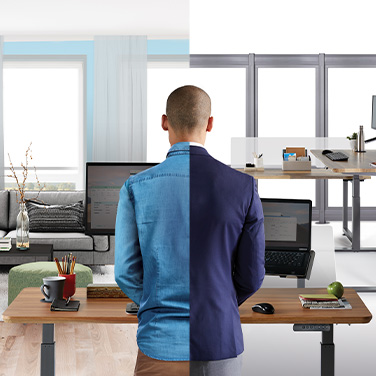 professional works in office setting with privacy panels to increase distance
