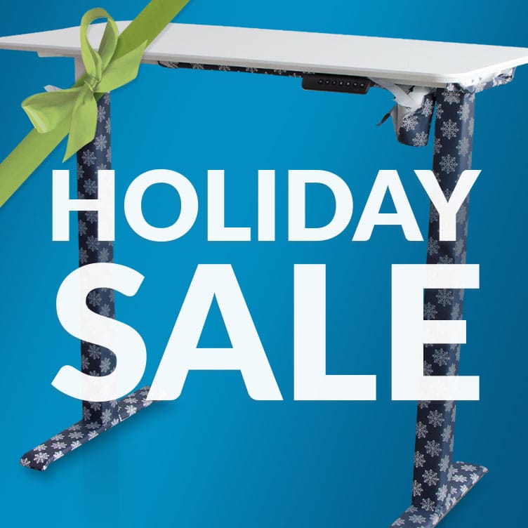 holiday sale in front of a half unwrapped electric standing desk