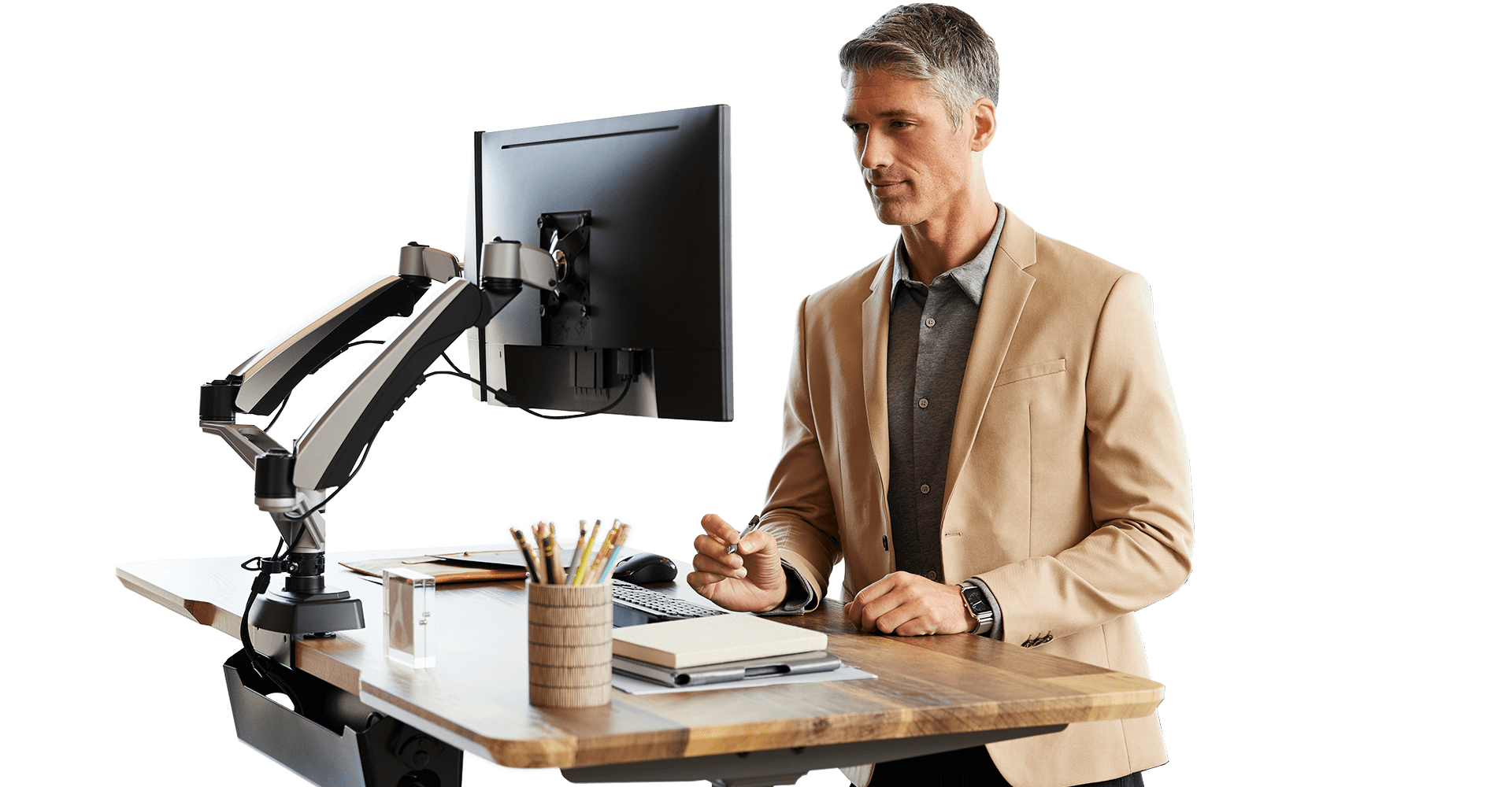 professional working at an electric standing desk work station with mounted monitors