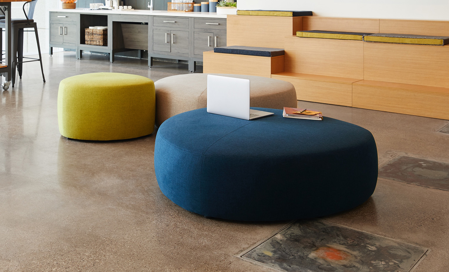 two large ottomans and one small ottoman appear in office setting
