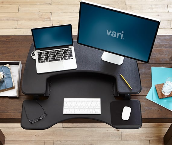 overhead view of varidesk converter on existing desk with laptop and monitor