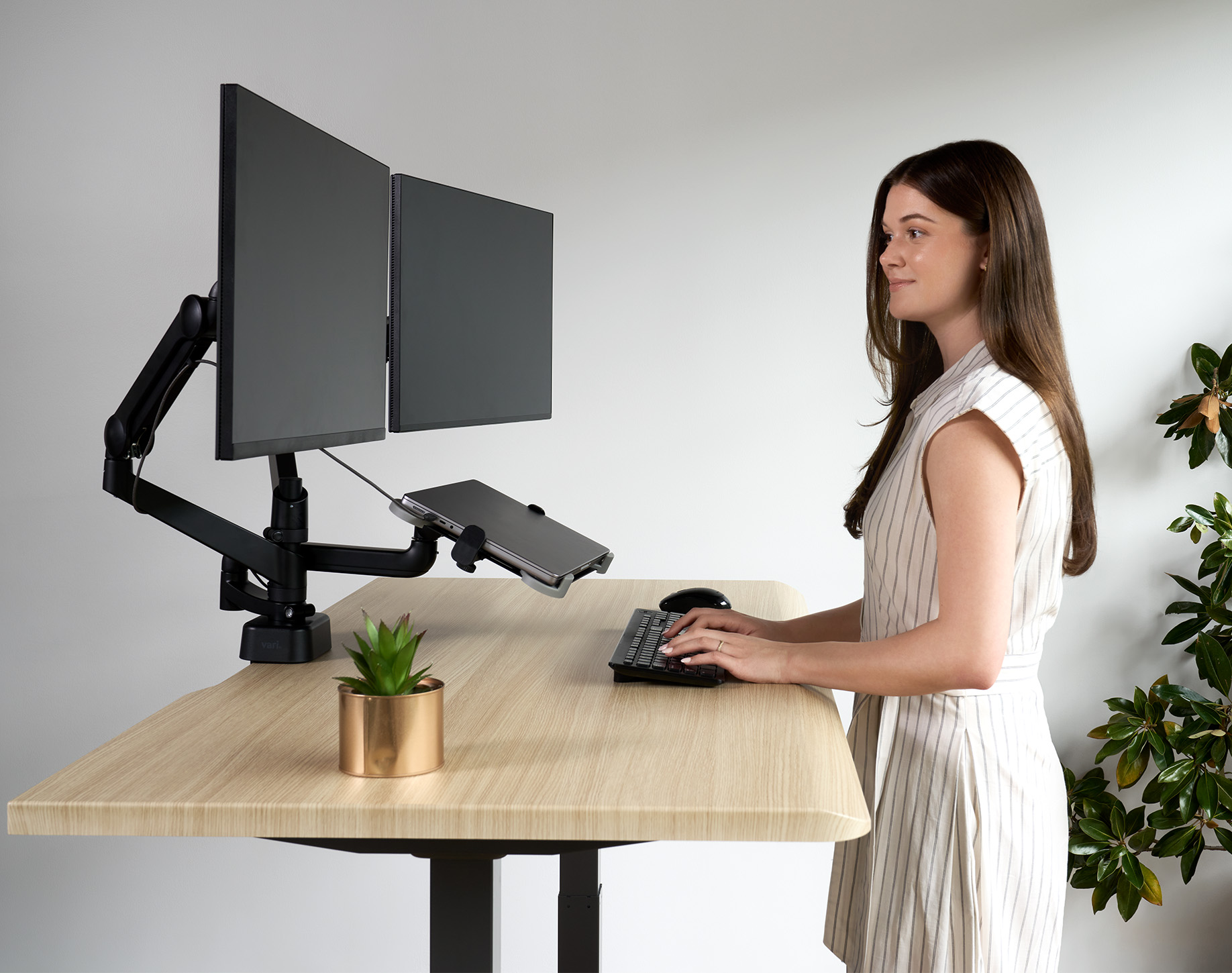 adjustable monitor arms hold computers high enough so that an office professional can comfortably use the computer
