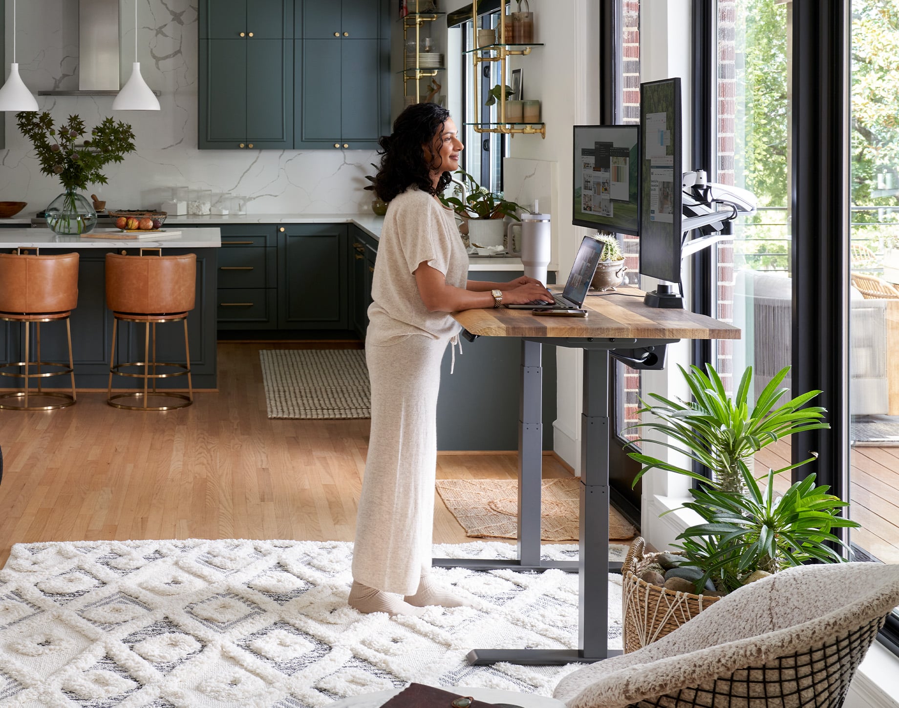 professional standing at vari electric standing desk in office setting